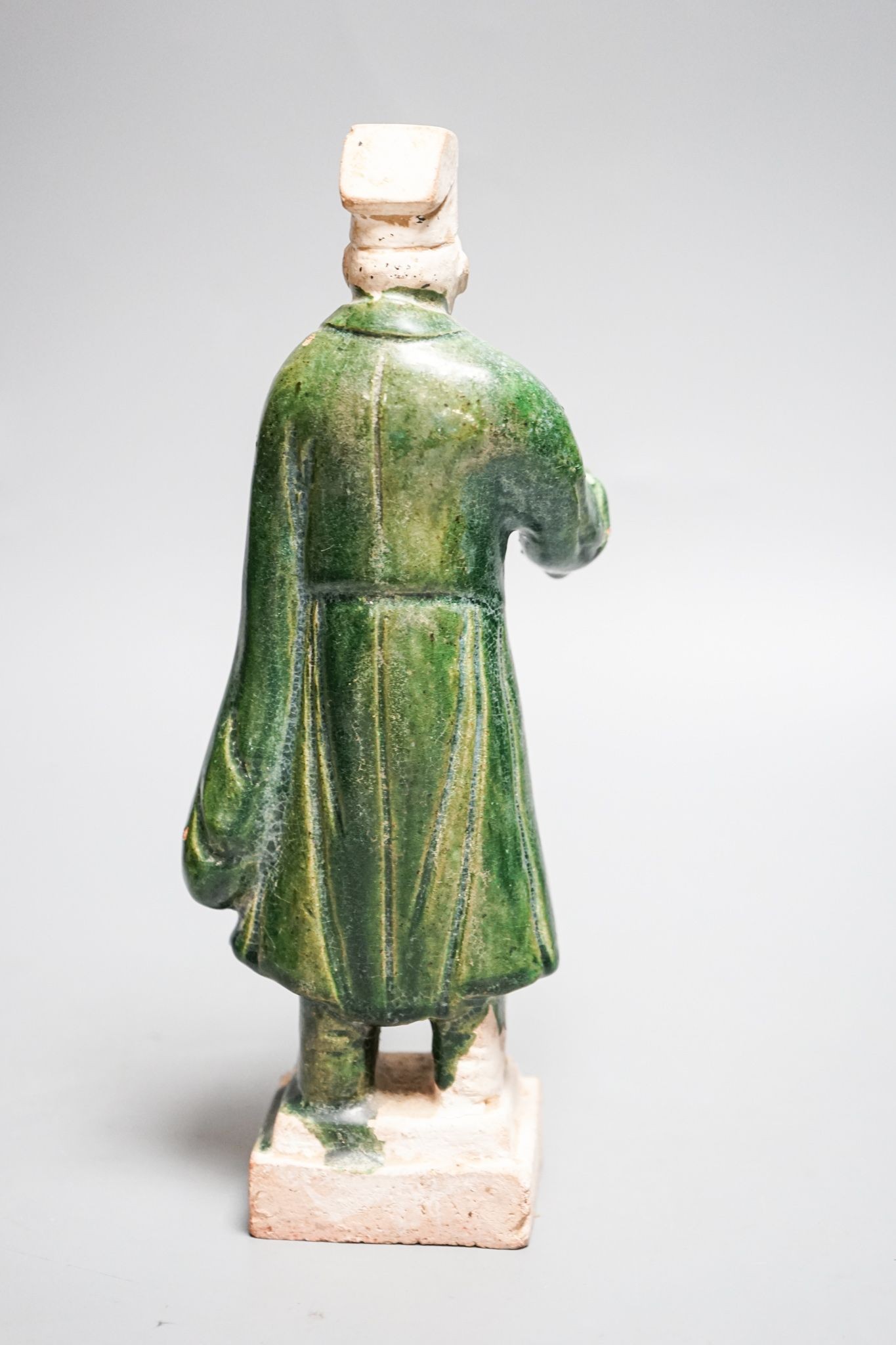 A Chinese Ming green glazed figure of an official 23cm